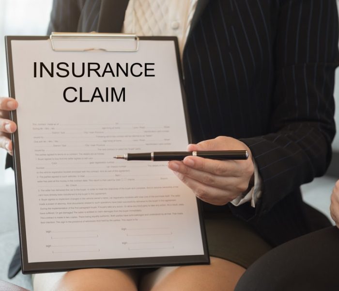 Insurance,Agent,Sends,Pen,And,Insurance,Claim,Form,For,Signing